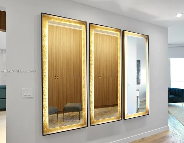 a bedroom with a bed and a lamp on dresser