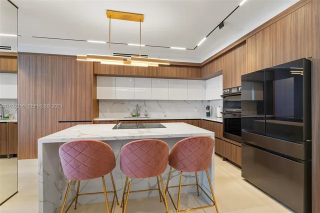 a kitchen with a table chairs microwave and refrigerator