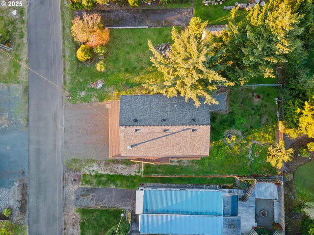 an aerial view of a house with a yard