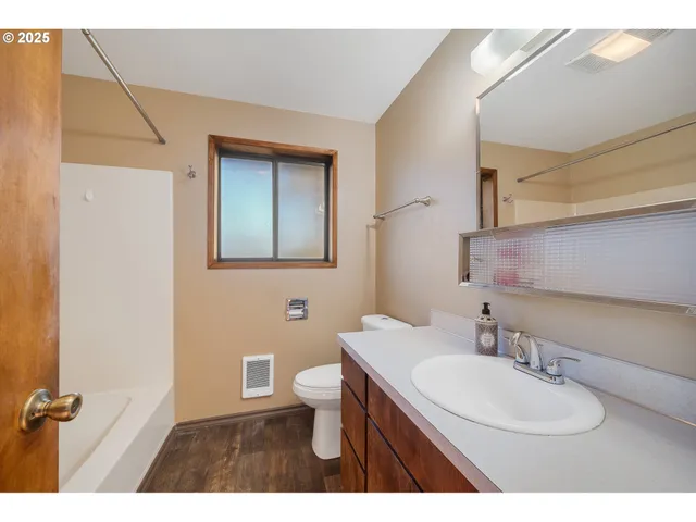 a bathroom with a sink toilet a mirror and vanity