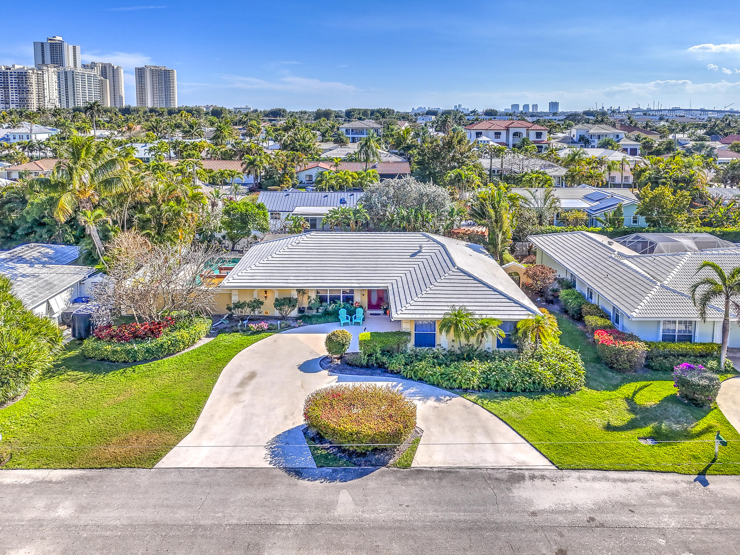1191 Emerald Drive Singer Island, FL 33404 - Photo 1 of 60 a aerial view of a house with a yard and lake view