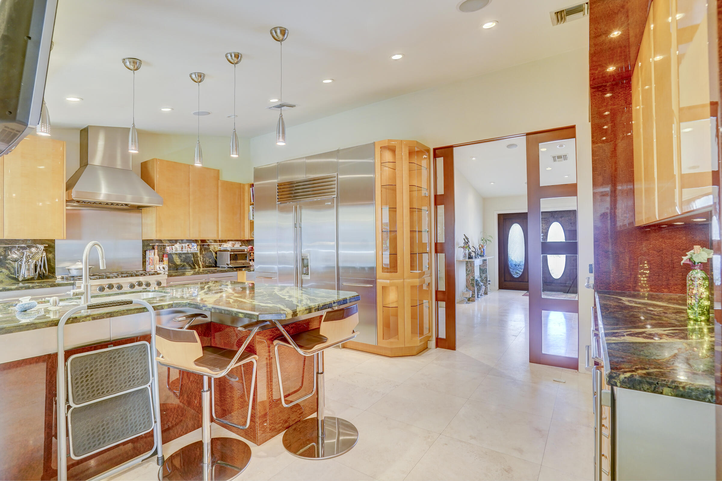 1191 Emerald Drive Singer Island, FL 33404 - Photo 15 of 60 a kitchen with a sink a stove and chairs