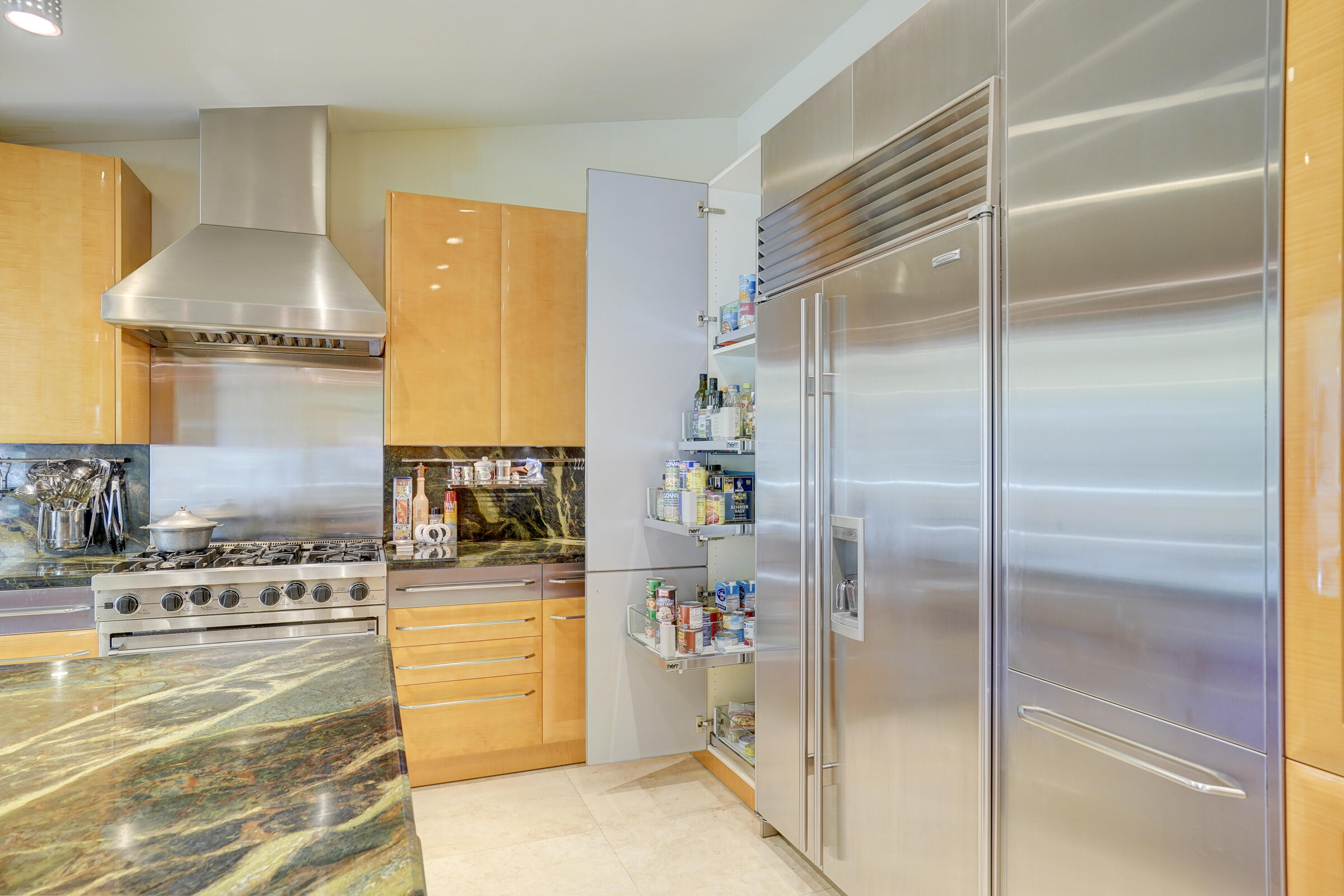1191 Emerald Drive Singer Island, FL 33404 - Photo 21 of 60 a kitchen with a refrigerator and a stove