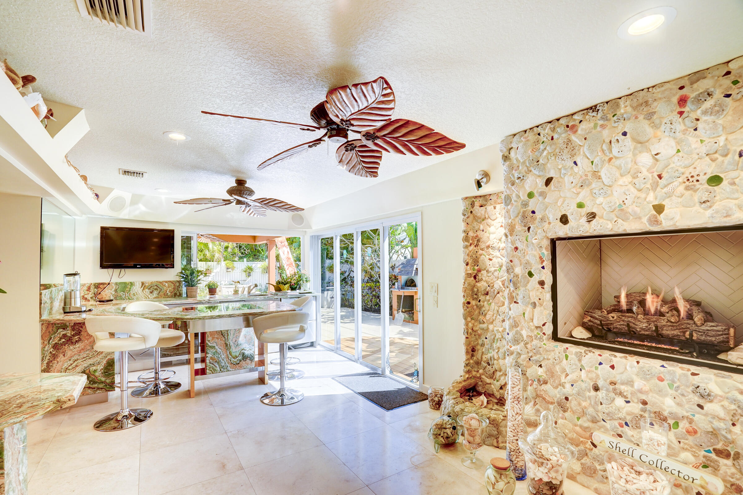 1191 Emerald Drive Singer Island, FL 33404 - Photo 28 of 60 a view of a livingroom with furniture and a flat screen tv