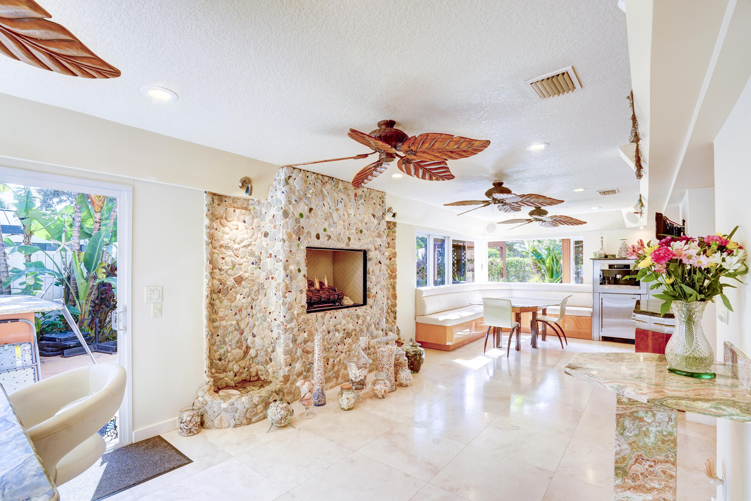 1191 Emerald Drive Singer Island, FL 33404 - Photo 30 of 60 a living room with furniture and a fireplace