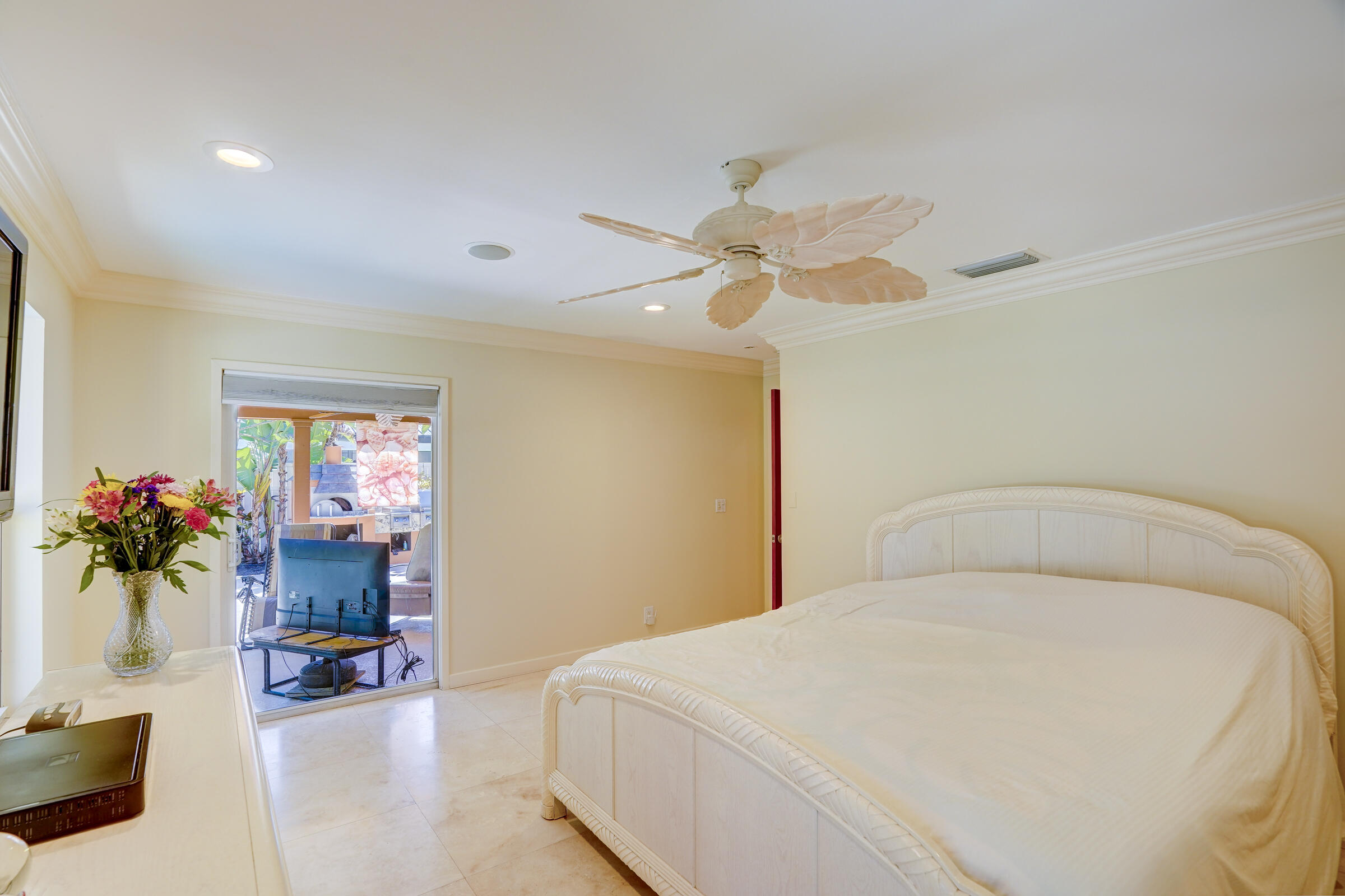 1191 Emerald Drive Singer Island, FL 33404 - Photo 32 of 60 a bedroom with a bed and a chandelier