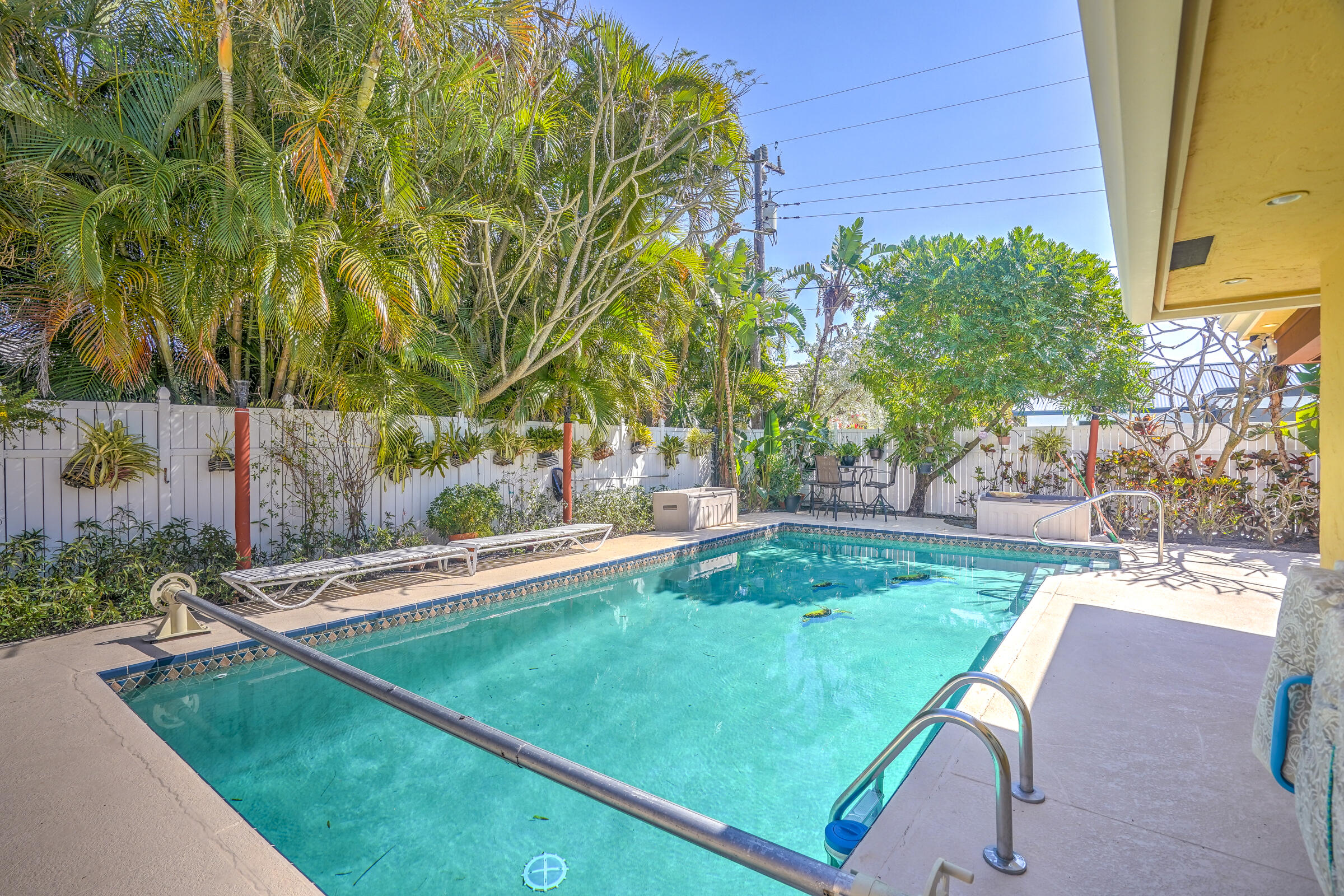 1191 Emerald Drive Singer Island, FL 33404 - Photo 47 of 60 a view of a backyard with swimming pool