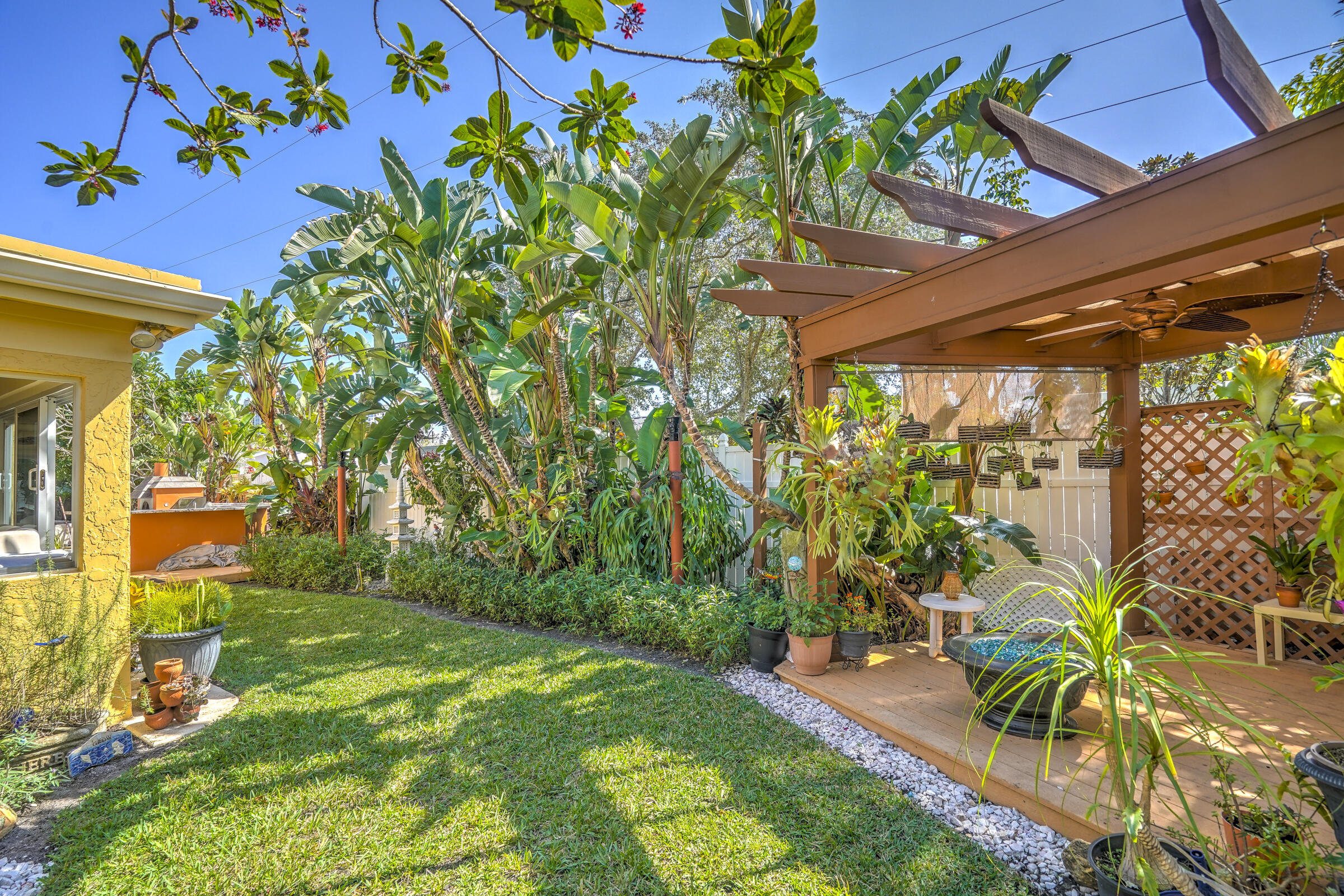 1191 Emerald Drive Singer Island, FL 33404 - Photo 50 of 60 a view of a yard with a tree