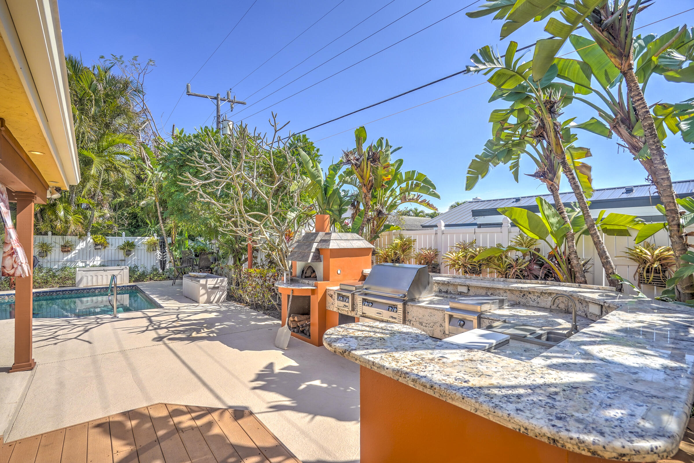 1191 Emerald Drive Singer Island, FL 33404 - Photo 53 of 60 a view of a swimming pool with a lounge chairs