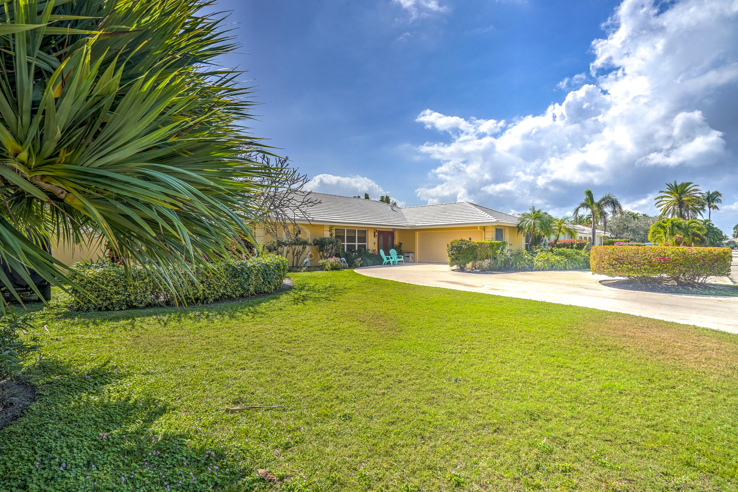 1191 Emerald Drive Singer Island, FL 33404 - Photo 57 of 60 a front view of a house with a yard table and chairs