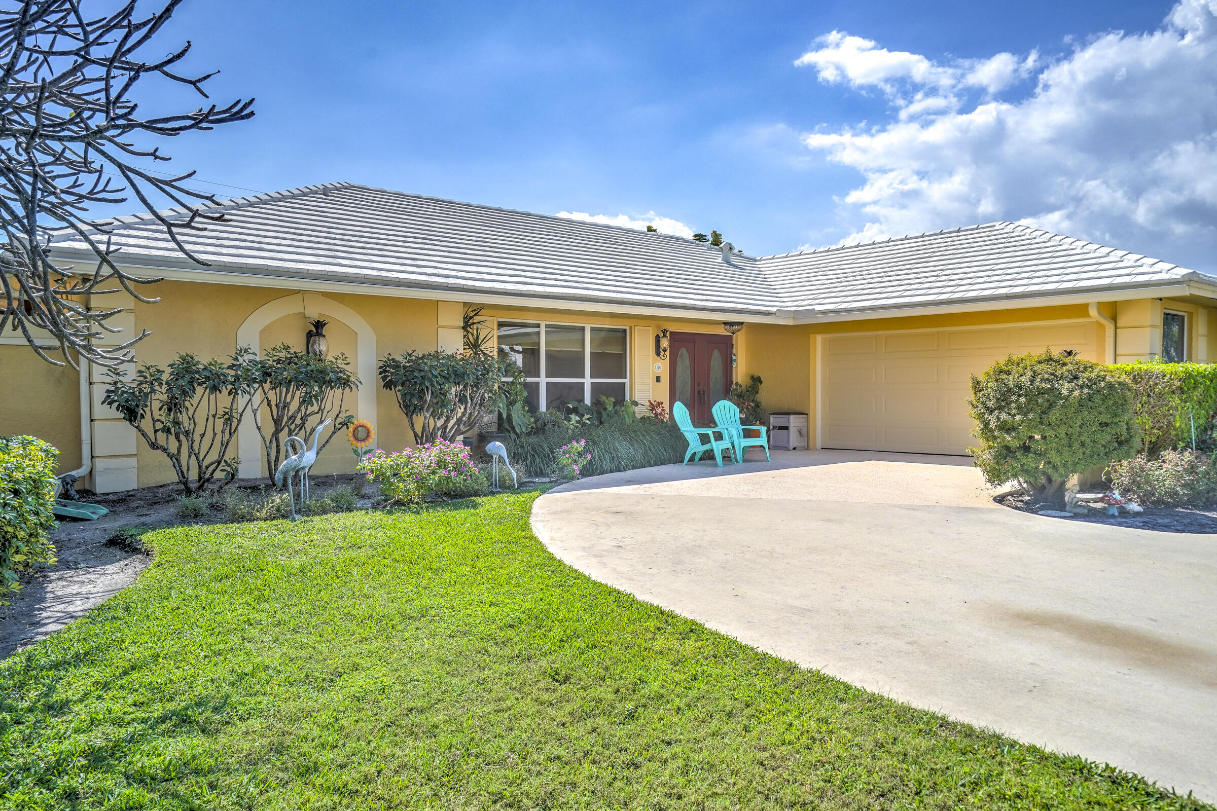 1191 Emerald Drive Singer Island, FL 33404 - Photo 58 of 60 a front view of a house with garden