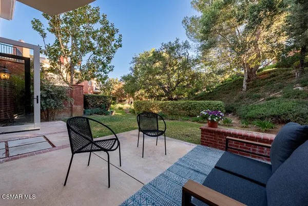 a view of a chairs and table in the patio