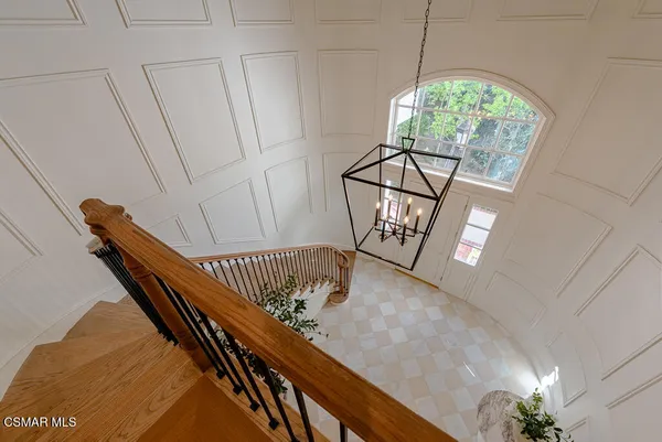 a view of staircase going with railing and white walls