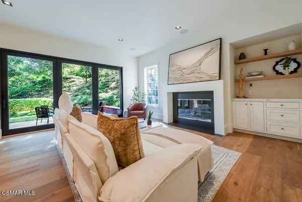 a living room with furniture fireplace and window