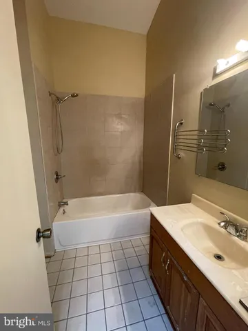a bathroom with a sink a mirror and a bathtub