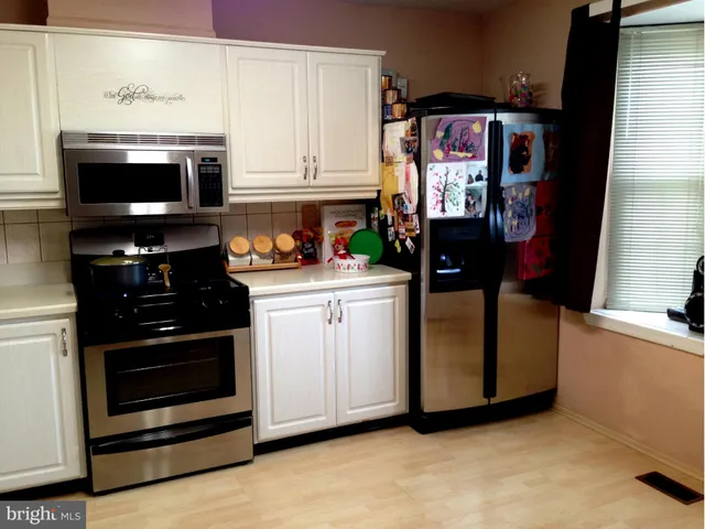 a kitchen with stainless steel appliances granite countertop a stove and a microwave