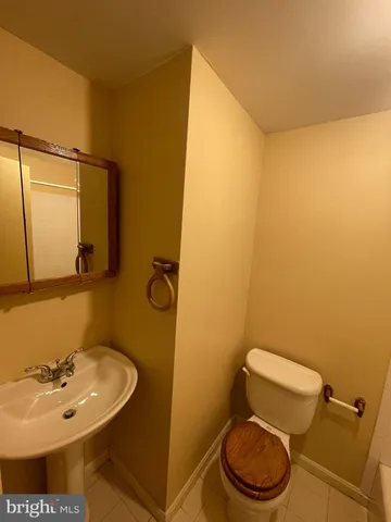 a bathroom with a sink a toilet and mirror