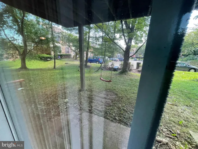 a view of a yard with table and chairs under an umbrella