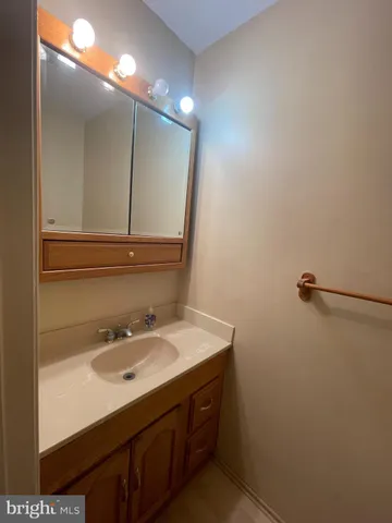 a bathroom with a sink vanity and mirror
