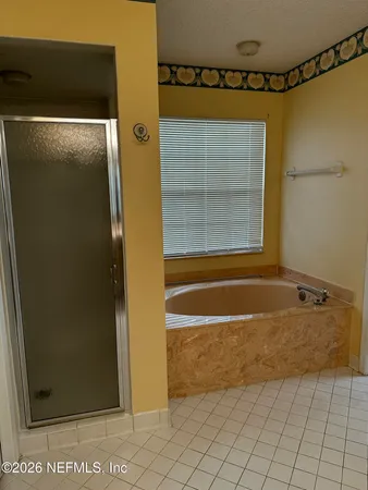 a bathroom with a tub and a shower