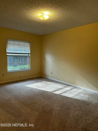 an empty room with a empty space and windows