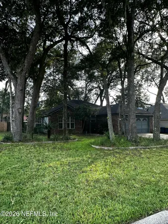 a backyard of a house with lots of green space