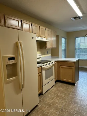 a kitchen with stainless steel appliances a refrigerator sink and cabinets