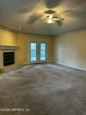 a view of an empty room with a fireplace