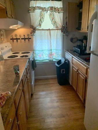 366 Centre Street Boston, MA 02122 - Photo 2 of 14 a kitchen with a refrigerator and a stove