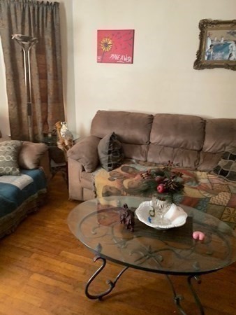 366 Centre Street Boston, MA 02122 - Photo 6 of 14 a living room with furniture and a table