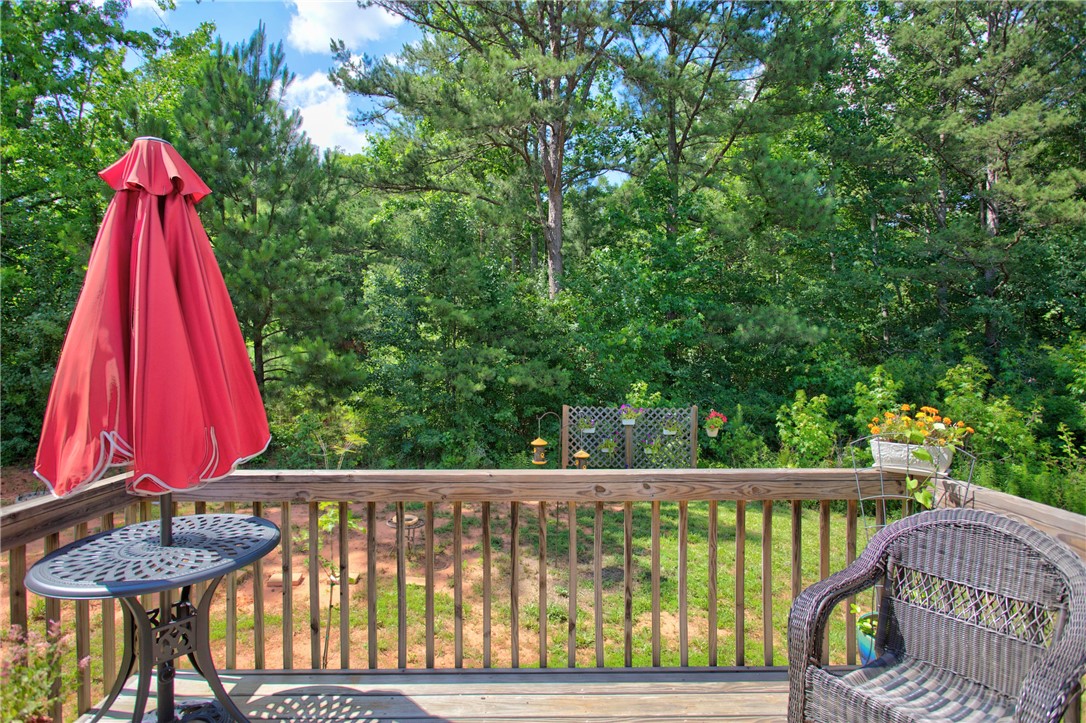 405 Pawnee Drive Walhalla, SC 29691 - Photo 22 of 36 A tranquil outdoor living space with a wooden deck overlooks a verdant landscape.