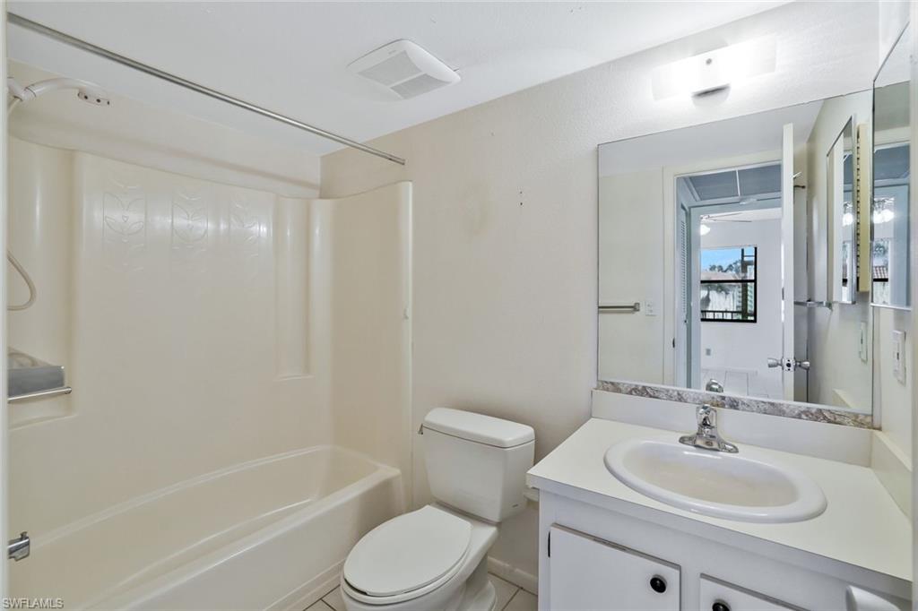 4345 27th Court Southwest, Unit 204 Naples, FL 34116 - Photo 17 of 25 a bathroom with a sink toilet and shower