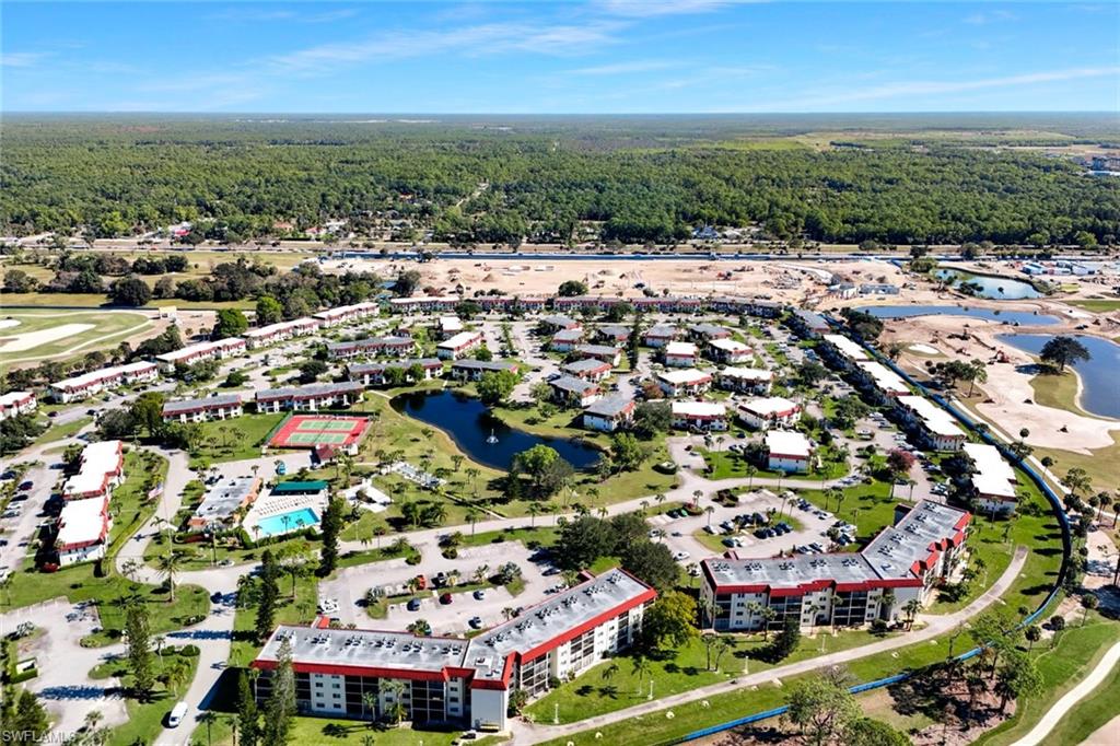 4345 27th Court Southwest, Unit 204 Naples, FL 34116 - Photo 21 of 25 an aerial view of residential houses with outdoor space