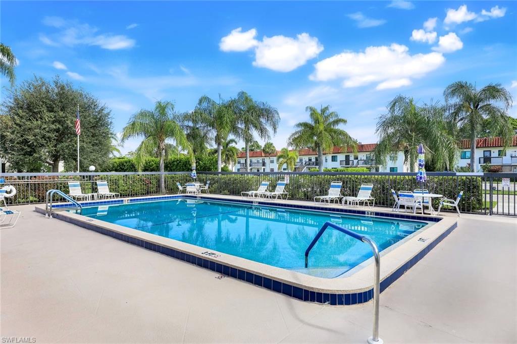 4345 27th Court Southwest, Unit 204 Naples, FL 34116 - Photo 22 of 25 a view of swimming pool with outdoor seating and plants