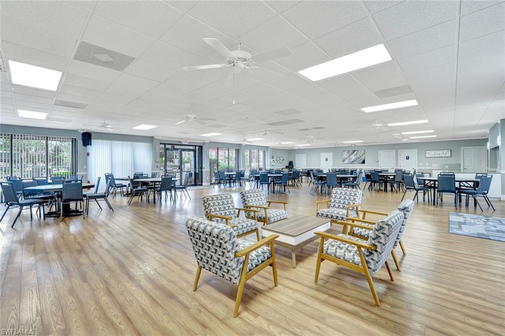 4345 27th Court Southwest, Unit 204 Naples, FL 34116 - Photo 23 of 25 a living room with lots of furniture wooden floor and a table
