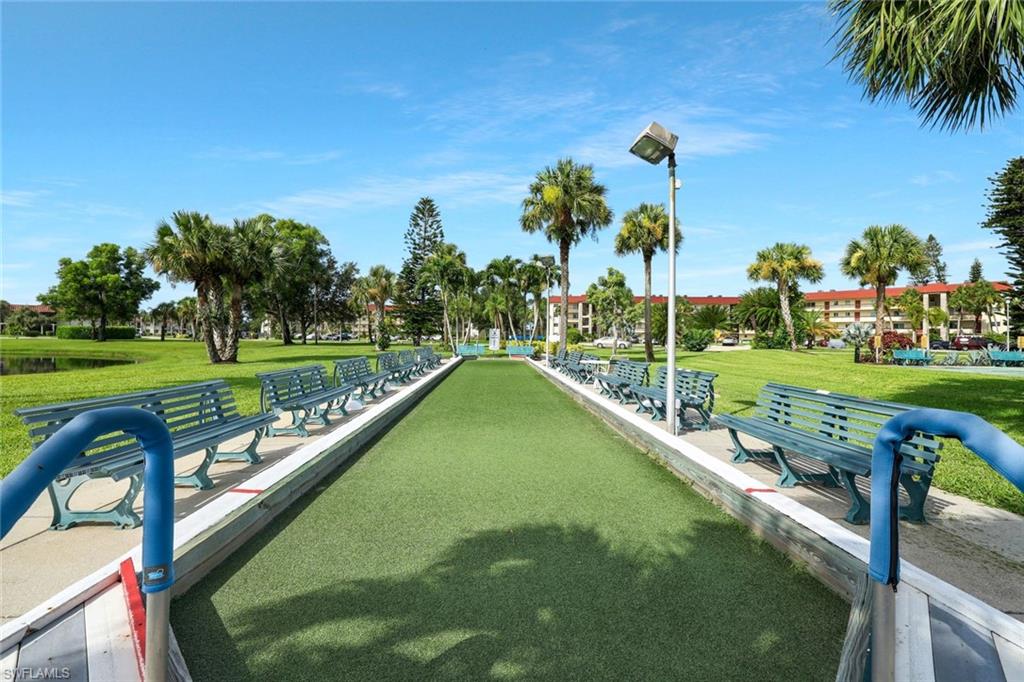 4345 27th Court Southwest, Unit 204 Naples, FL 34116 - Photo 24 of 25 a view of a swimming pool and trees in the background