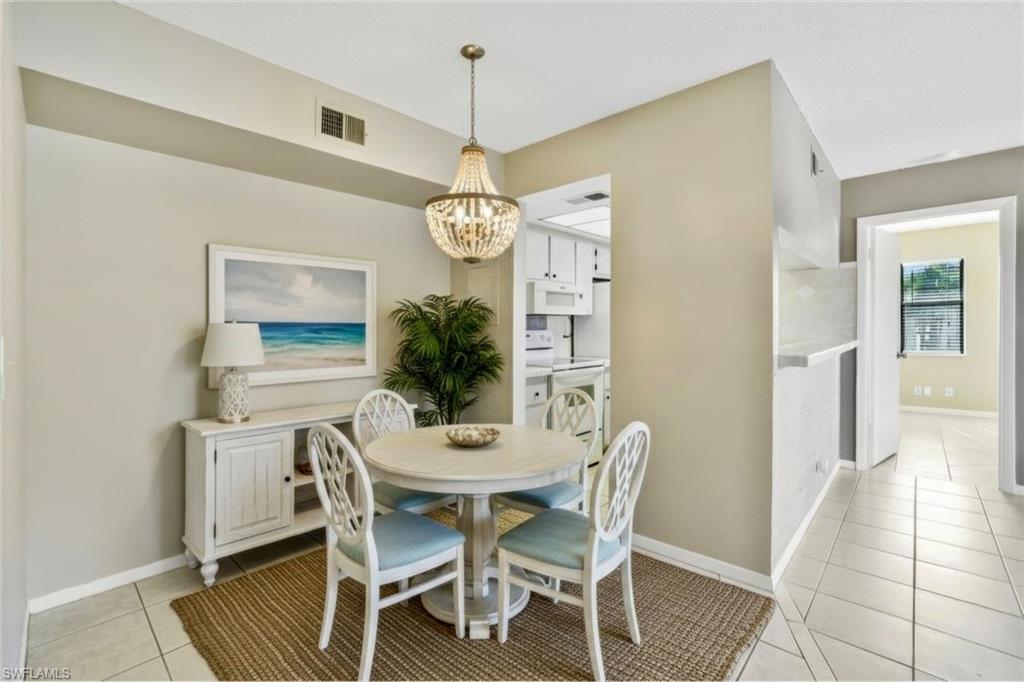 4345 27th Court Southwest, Unit 204 Naples, FL 34116 - Photo 3 of 25 a dining room with furniture and window