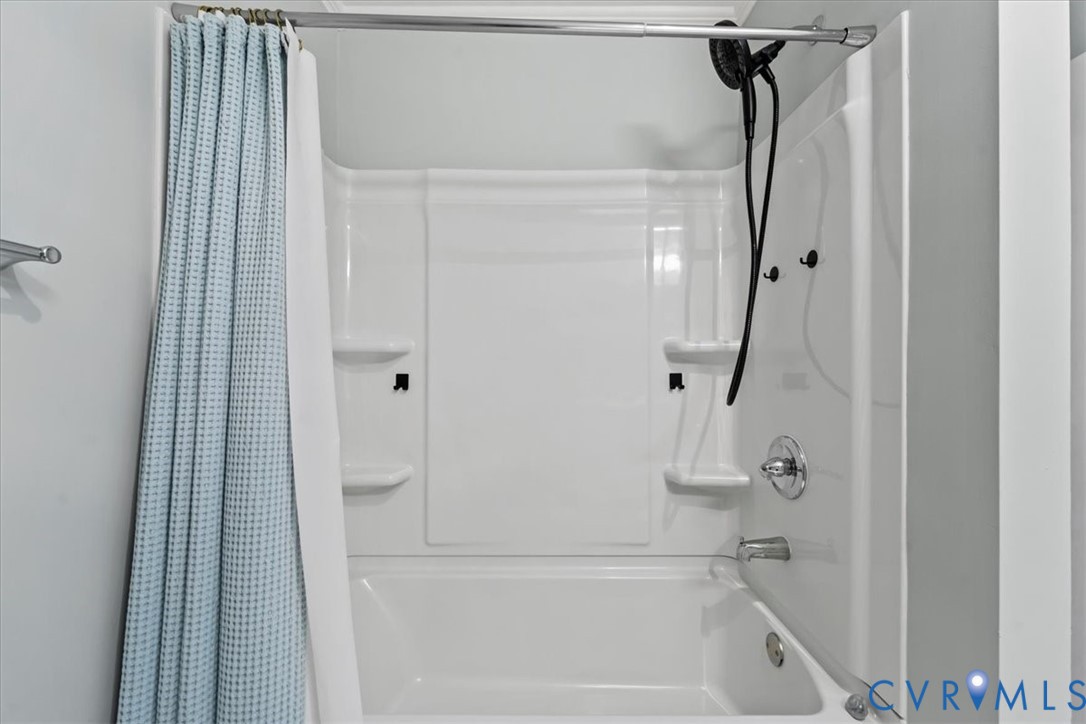 7010 Slate Road Chesterfield, VA 23832 - Photo 23 of 45 White tub and shower combination featuring integra