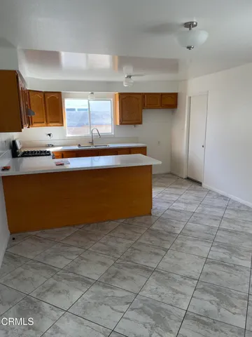 a view of kitchen with stainless steel appliances a sink and a counter top space