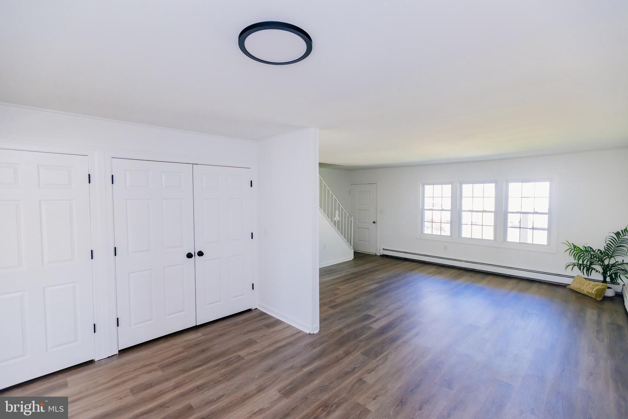 21 Velvet Lane Levittown, PA 19054 - Photo 16 of 47 a view of an empty room with wooden floor and a window