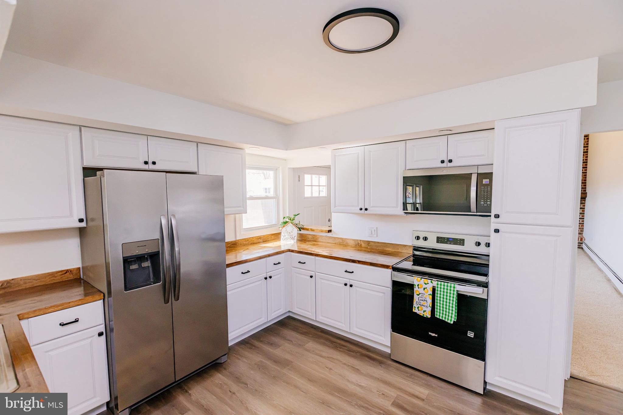 21 Velvet Lane Levittown, PA 19054 - Photo 2 of 47 a kitchen with stainless steel appliances a stove refrigerator sink and microwave