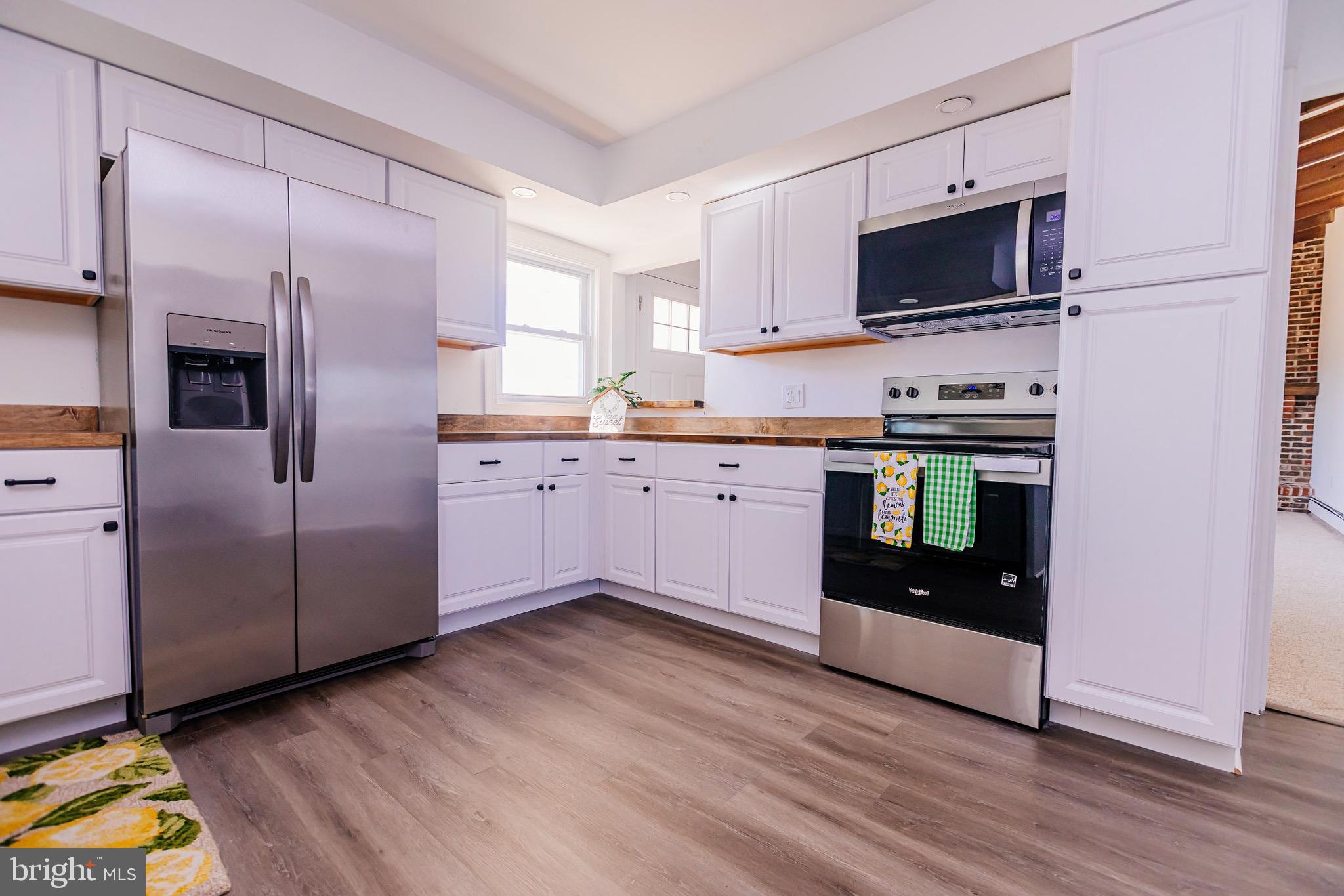 21 Velvet Lane Levittown, PA 19054 - Photo 5 of 47 a kitchen with stainless steel appliances granite countertop a stove a sink and a microwave