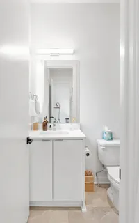 a bathroom with a sink a toilet and mirror