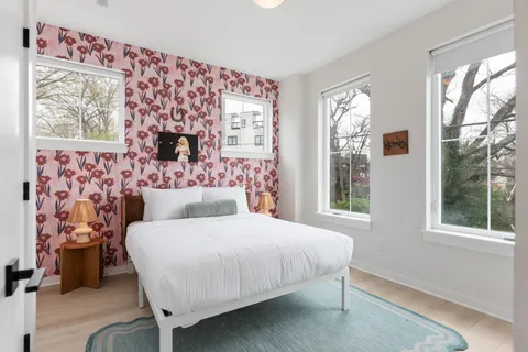 a bedroom with a large bed and a window