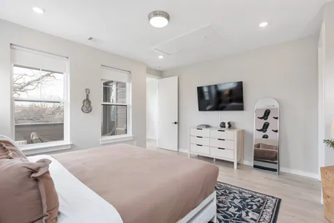 a bedroom with a bed and a flat screen tv