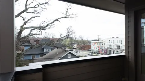 a view of a balcony with trees