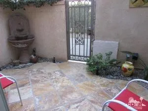 a room with lots of potted plants and glass windows