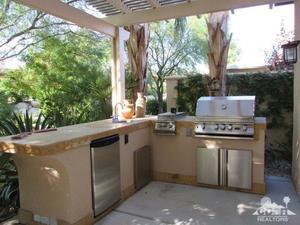 49549 Lewis Road Indio, CA 92201 - Photo 14 of 17 a view of a kitchen with a stove and a large tree