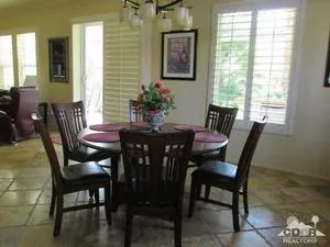a view of a dining room with furniture and window