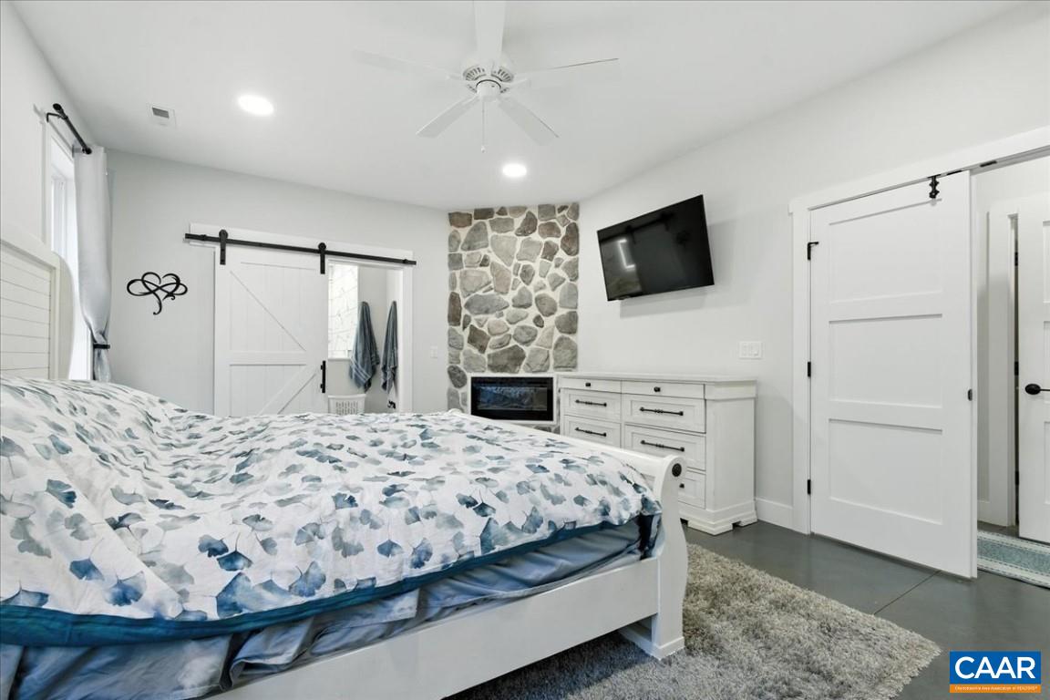 1568 Bent Creek Road Concord, VA 24538 - Photo 41 of 75 a bedroom with a bed and a flat screen tv